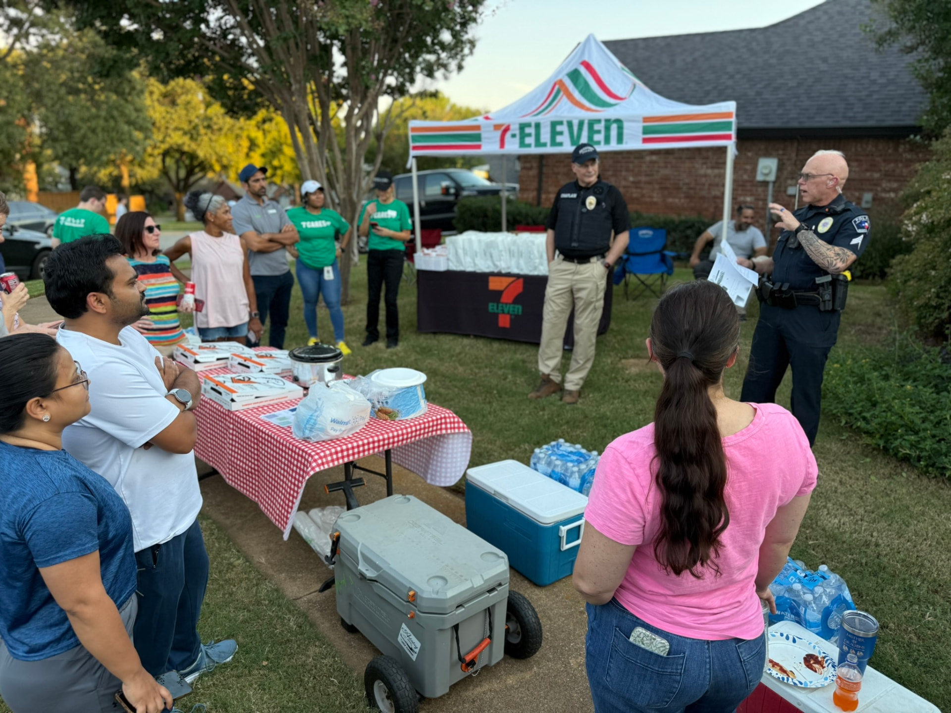 Bedford police officers speaking with neighbors at a community safety gathering